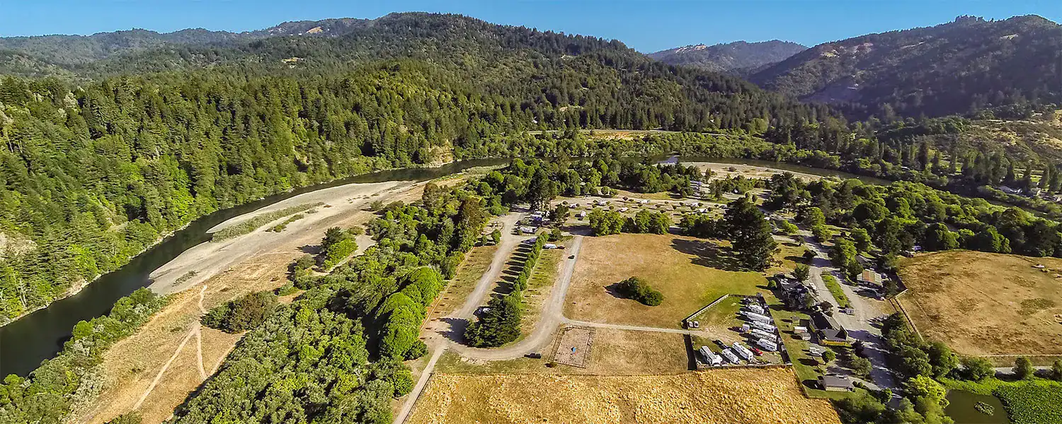 Enjoying RVing, traveling, camping, and nature at a scenic outdoor location with RVs and lush greenery.